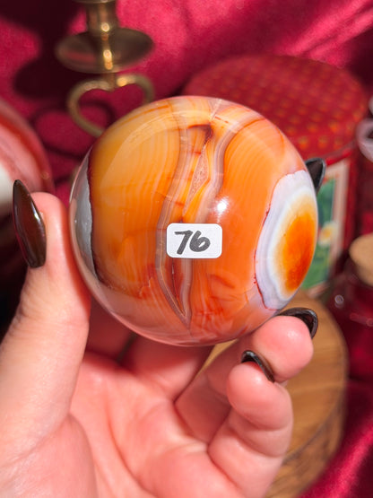 Rainbow banded carnelian sphere 65mm