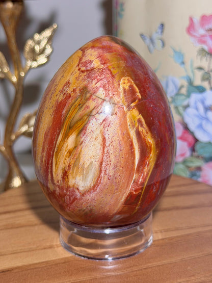 Vibrant red petrified wood egg with sparkling quartz pockets