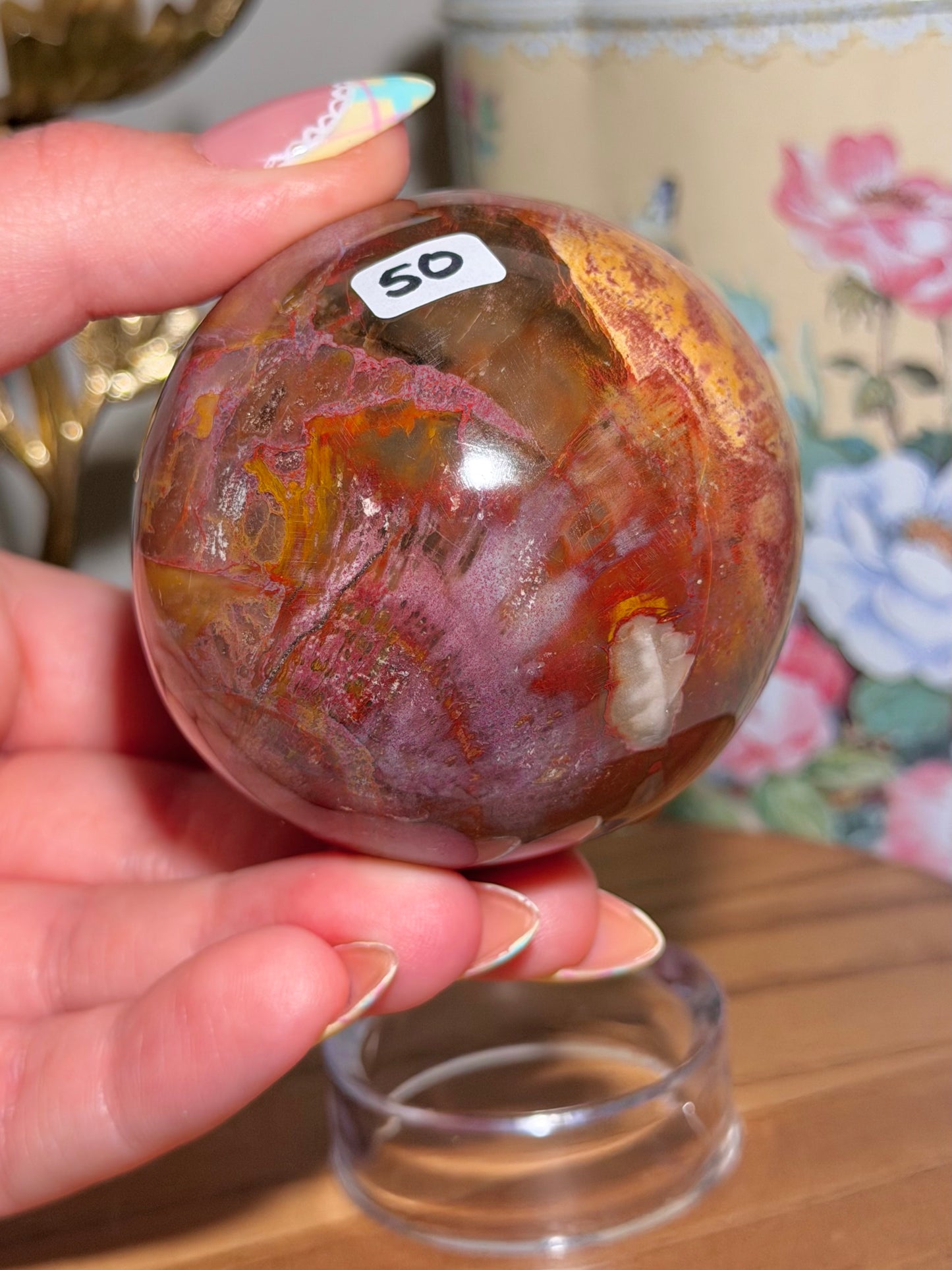 Vibrant red petrified wood egg with sparkling quartz pockets