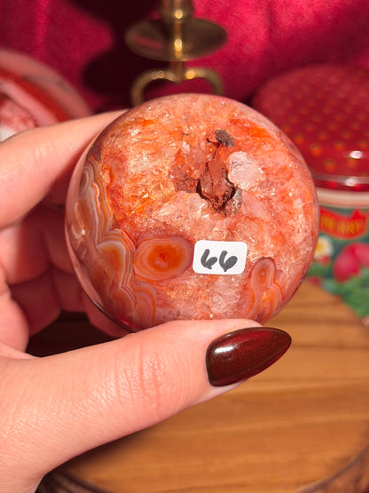 Mossy carnelian sphere with quartz cave