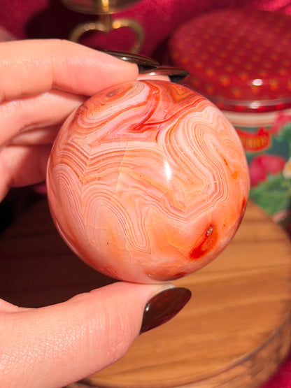 Peachy pink carnelian sphere with adorable scalloped banding