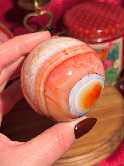 Rainbow banded carnelian sphere 65mm