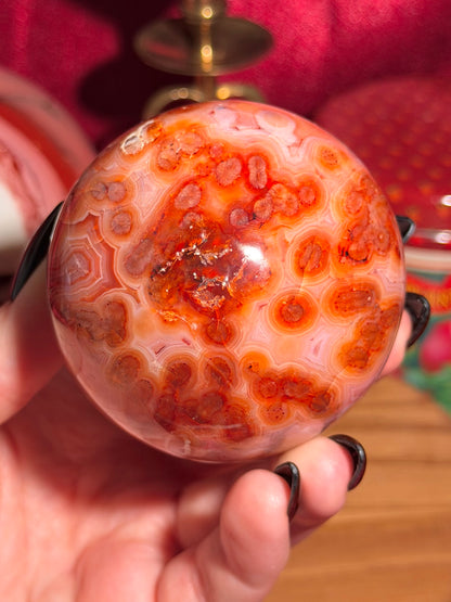 Mossy carnelian sphere with quartz cave