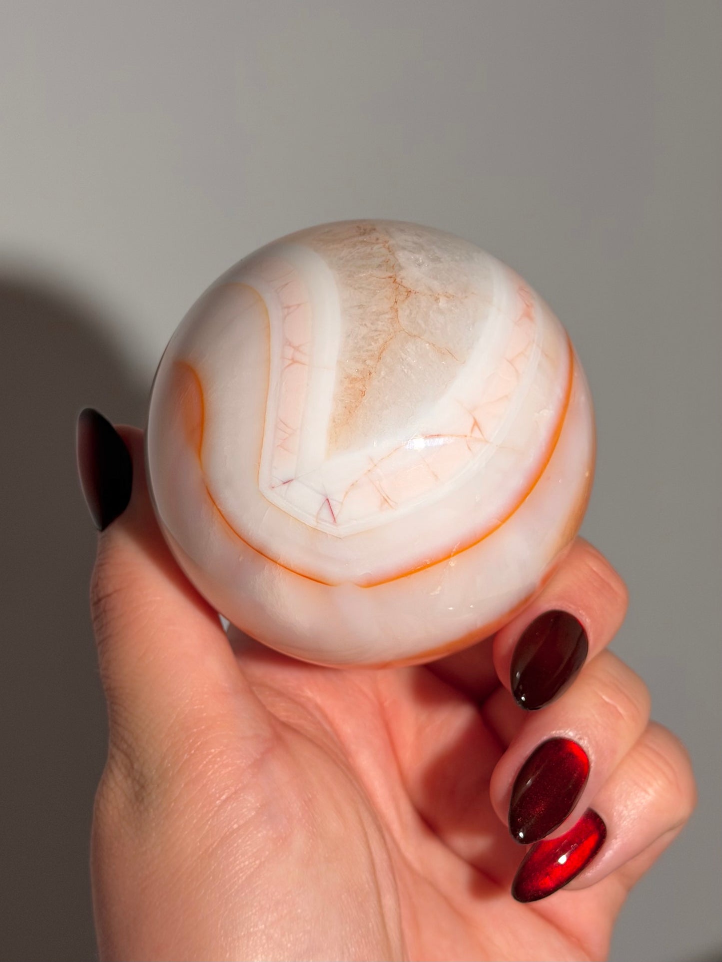 Pastel cool toned pink carnelian sphere with quartz 75mm