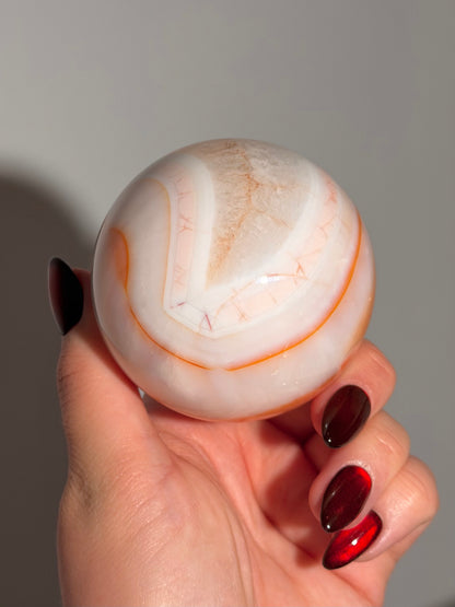 Pastel cool toned pink carnelian sphere with quartz 75mm
