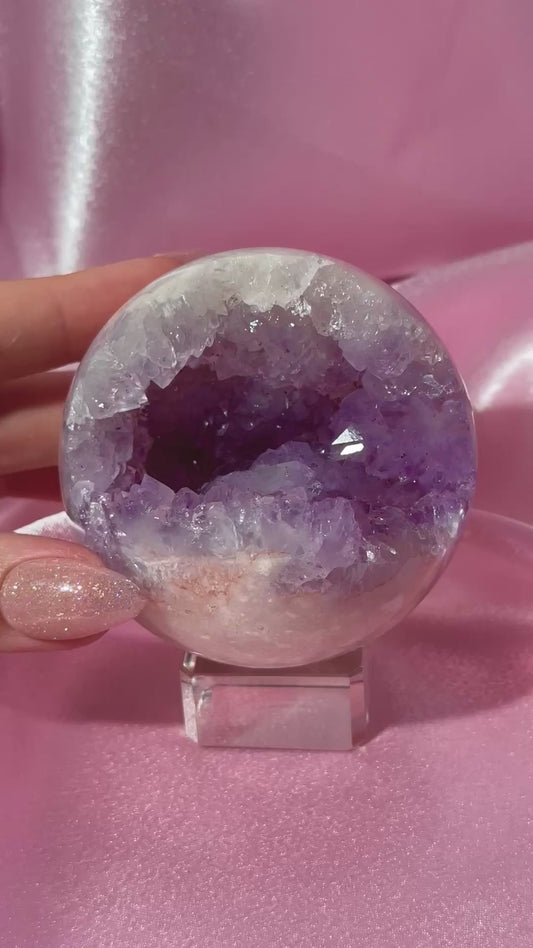 Brazilian pink amethyst sphere with purple druzy cave