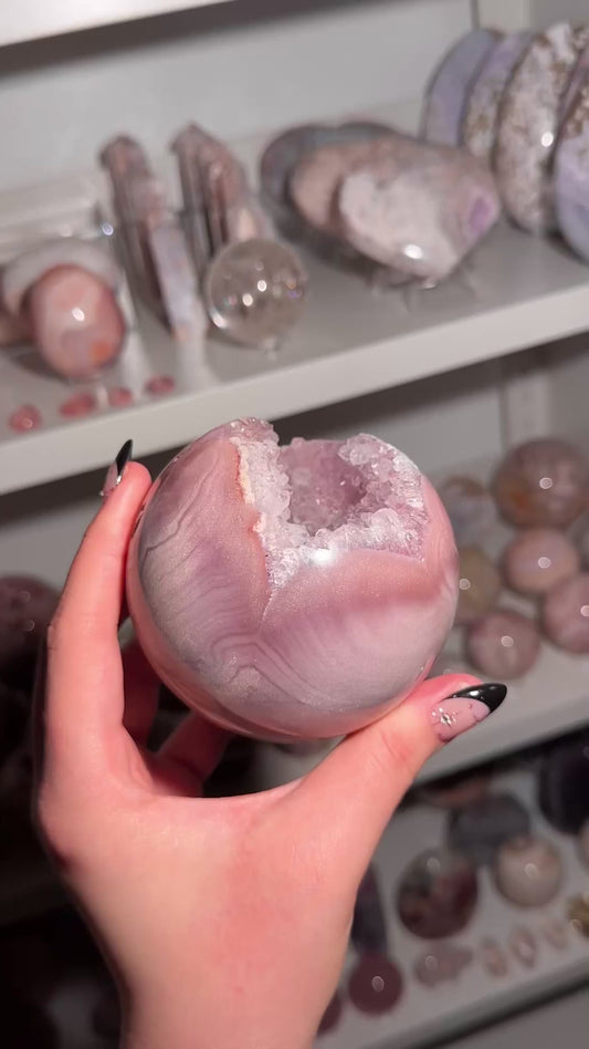Lavender-toned glittery Brazilian pink amethyst sphere with stunning quartz cave